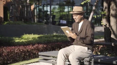 Asian freelancer put on brown hat working outdoor. Office worker or businessman  Stock Footage 144518621