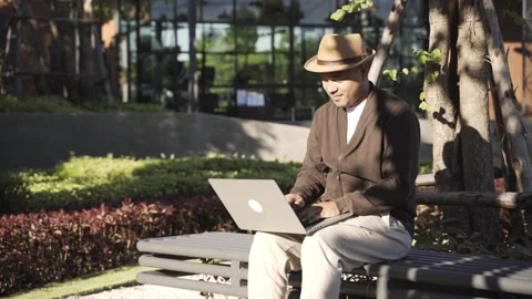 Asian freelancer put on brown hat working outdoor. Office worker or businessman  Stock Footage 144518721