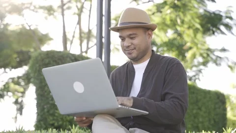 Asian freelancer put on brown hat working outdoor. Office worker or businessman  Stock Footage 144518726