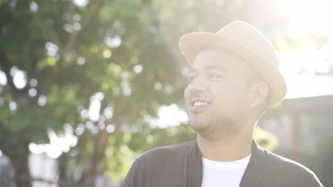 Asian freelancer put on brown hat working outdoor. Office worker or businessman  Video stock 144518992