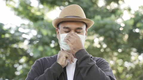 Asian freelancer put on brown hat wearing face mask working outdoor. Office work Stock-Footage 144519357