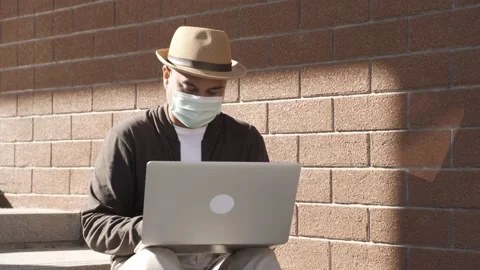 Asian freelancer put on brown hat and face mask working outdoor. Office worker o Stock-Footage 144519747