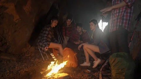 Asian friend groups having fun camping in cave. Video stock 121046802