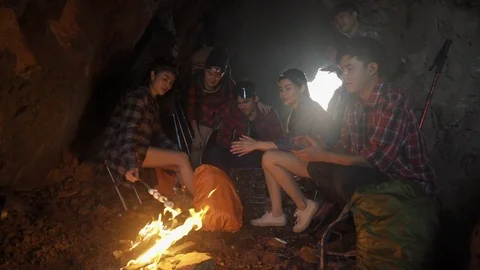 Asian friend groups having fun camping in cave. Video stock 121046855