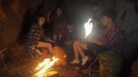 Asian friend groups having fun camping in cave. Video stock 121046965