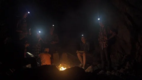 Asian friend groups having fun camping in cave. Видео 121047135