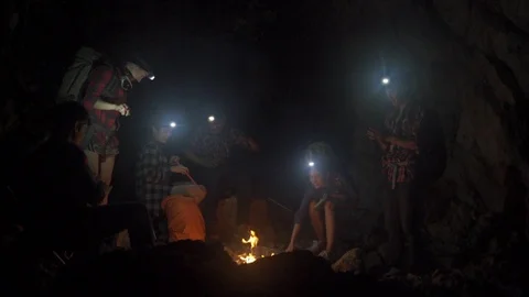 Asian friend groups having fun camping in cave. Video stock 121047177