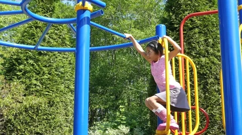 Asian Girl Climbing On Monkey Bars At Pl... | Stock Video