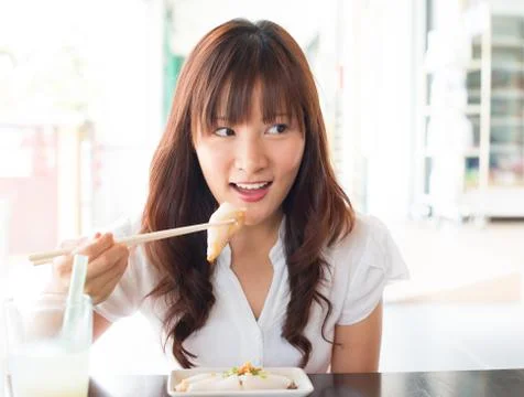 Asian girl eating dim sum Stock Photos