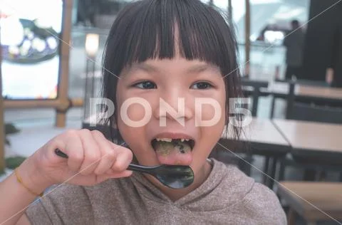 Asian girl eating Japanese green tea matcha ice cream Stock Photos