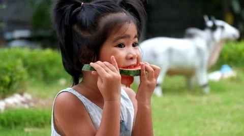 Asian girl eats slice of watermelon, cute girl enjoy eating watermelon Stock Footage