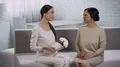 Asian girl giving present to mother, celebrating anniversary of marriage, family HD Footage