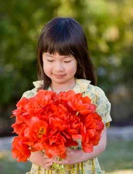 Asian girl holding bouquet of flowers Stock Photos