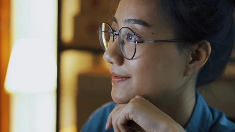 Asian girl looking at computer screen and wear eyeglasses at night Stock Footage 116033984