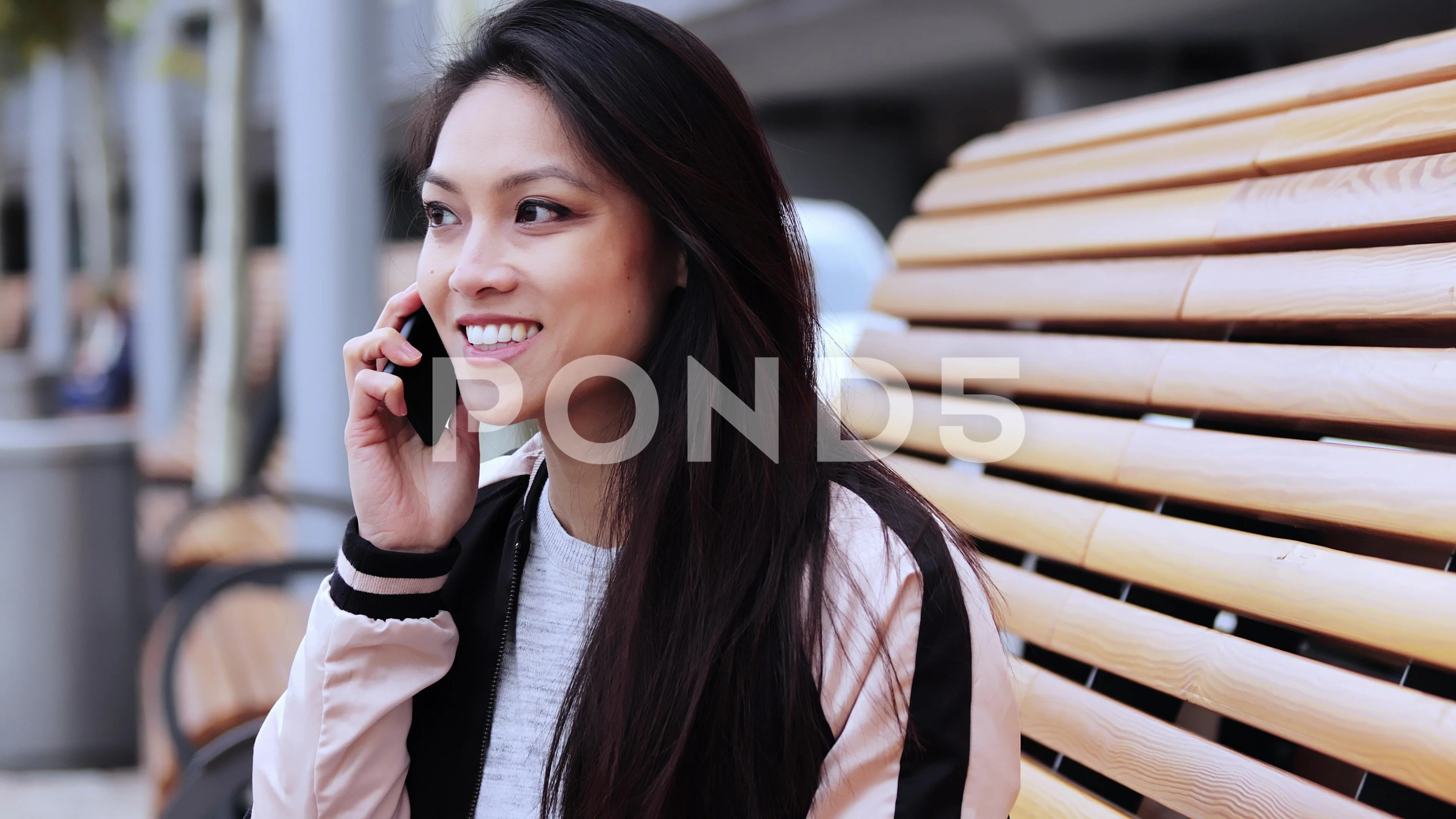 Asian girl with a pretty face sitting on a bench