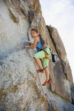 Asian girl rock climbing Stock Photos