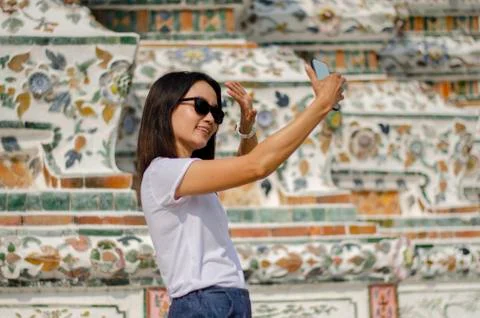 An Asian girl selfie with the Thai art wall Stock Photos