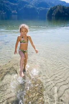 Asian girl splashing in lake Stock Photos