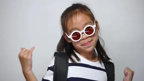 An Asian girl student with a backpack and sunglasses Stock Footage 315392353