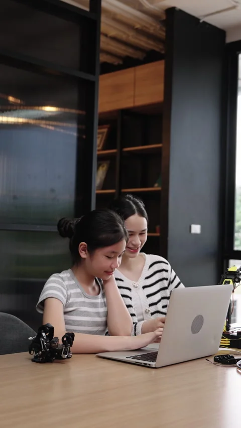 Asian girl study robotics using laptop in classroom, showing teamwork and Stock Footage 312419243