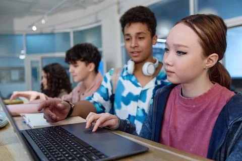 Asian Girl using Computer During Tech Class in School Foto stock
