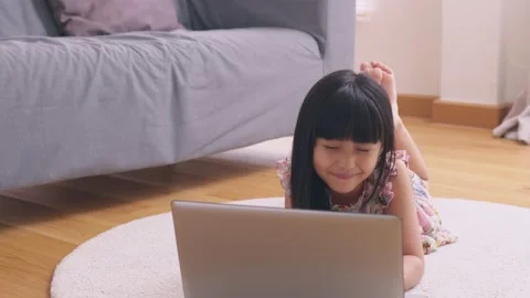 Asian girl using computer laptop playing game and social media or chatting wi Stock Footage 175761640