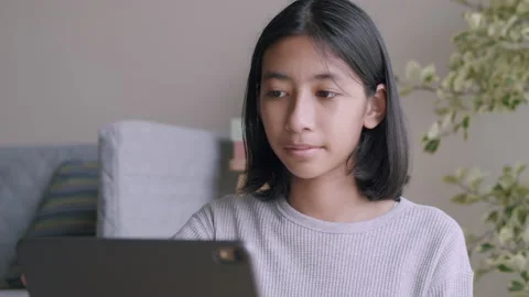 Asian girl using  laptop computer while sitting in the living room Stock Footage 137861878