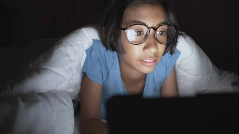 Asian girl using a tablet on a bed in her home Stock Footage 109553862