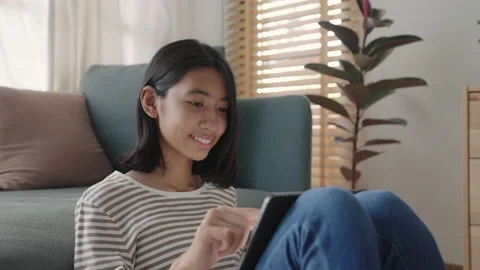 Asian girl using tablet digital at morning home Stock Footage 156367315