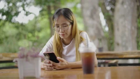 Asian girl ware mask protect virus using smartphone in cafe texting sharing mess Stock Footage 198297345