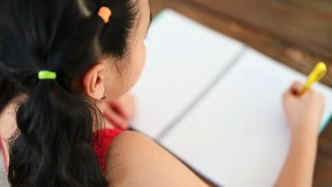 Asian girls write on paper at the table Stock Footage 117463529