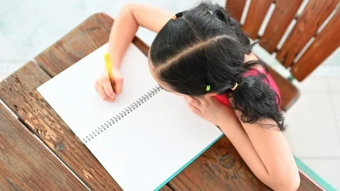 Asian girls write on paper at the table Stock Footage 118397637