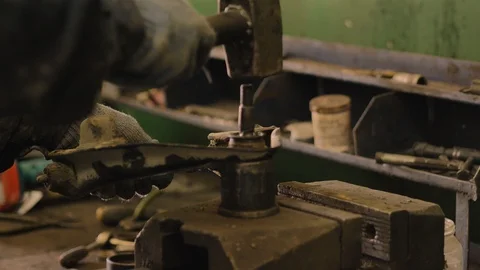 Asian in gloves and work clothes is repairing a spare part of a car in a garage Video stock 129833287