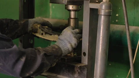 Asian in gloves and work clothes is repairing a spare part of a car in a garage Video stock 129833475