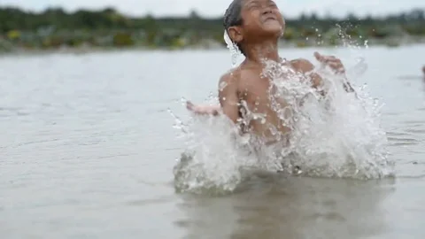 Asian group boy playing in the river with happy Stock Footage 79516964