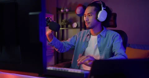 Asian guy blogger open computer getting ready to start record a podcast. Stock Footage 163769971