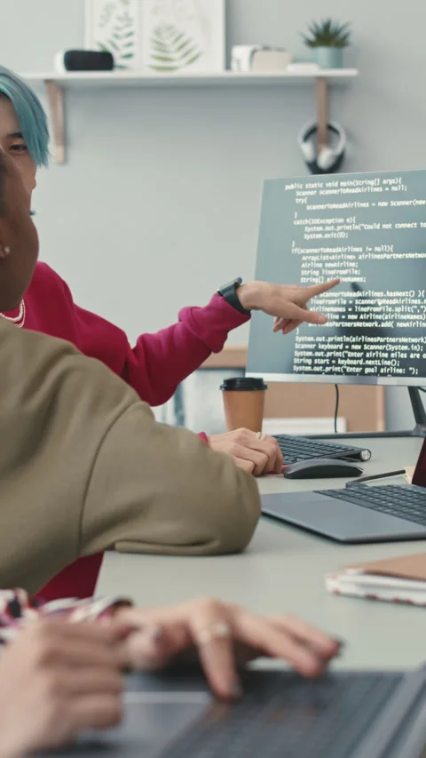 Asian Guy Discussing Program Code with Colleagues Stock Footage 240919889