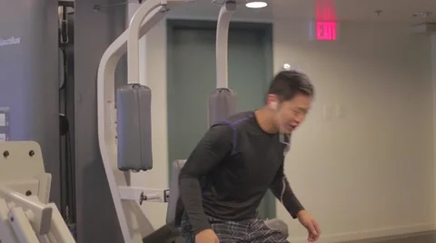 Asian guy does chest workout - pec deck Stock Footage 44934867