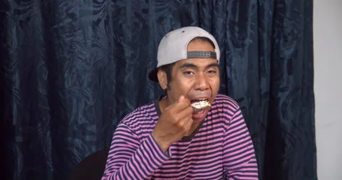 Asian guy eating Video stock 141225258