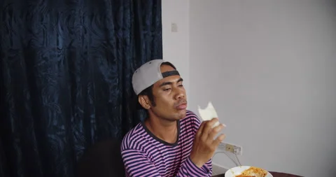 Asian guy eating raw cabbage alone Stock Footage 141221768