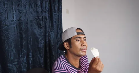 Asian guy eating raw cabbage alone Stock Footage 141229073