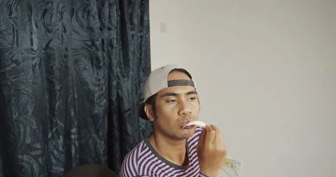 Asian guy eating raw cabbage Stock Footage 141277094