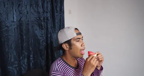Asian guy eating watermelon Video stock 141224465