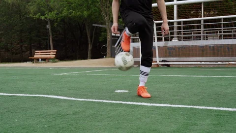 Asian guy training with soccer ball Stock Footage 129825545