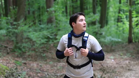 Asian guy walks through the forest and holds on backpack.hike in the forest Vidéo 252523747
