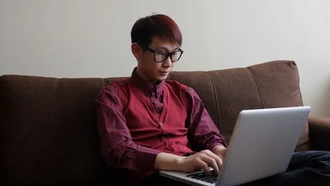 Asian guy working with laptop Stock Footage 87391682