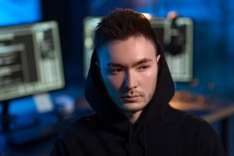 Asian hacker in dark room with computers at night Stock-Fotos