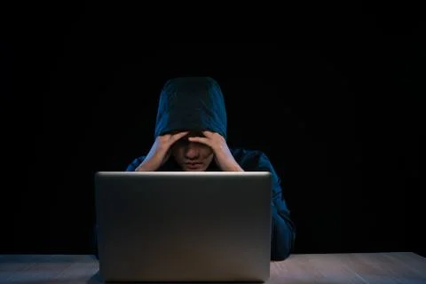 Asian hacker hacking computer network with laptop in dark. Cyber security con 스톡 사진