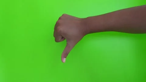 Asian hand showing thumbs down gesture on green background. dislike hand gesture Stock Footage 332152124