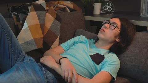 Asian Handsome  Guy is  Laying on the Sofa Stock Footage 148347219